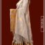 Model wearing beige handwoven linen saree with gold zari border from Mridula