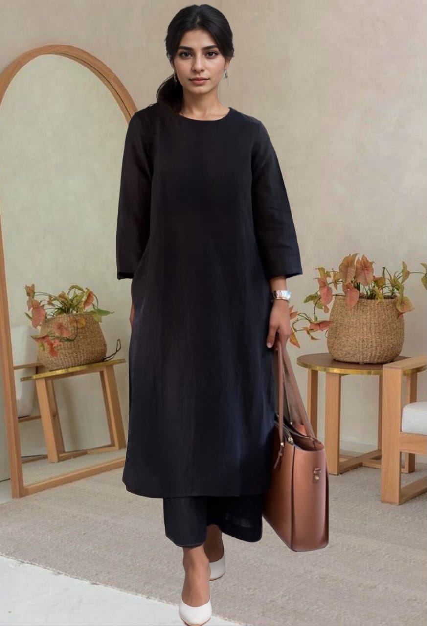 Woman wearing a black cotton kurta set with white heels and brown tote