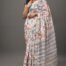 Model wearing floral cream Maheshwari silk saree with pastel prints and traditional pallu