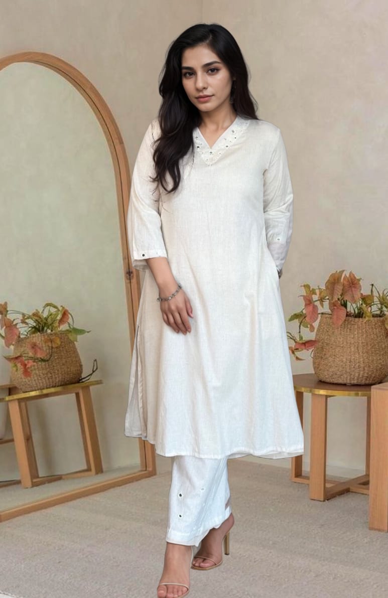 Woman wearing an elegant off-white cotton kurta set with embroidered details